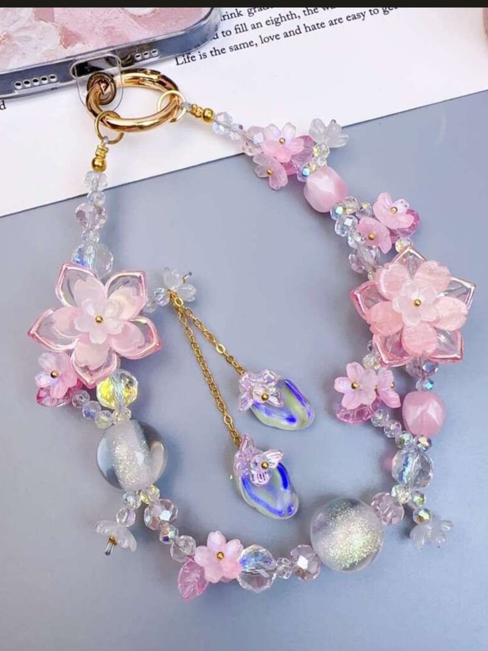 floral and beaded mobile phone lanyard featuring pastel-colored flowers,